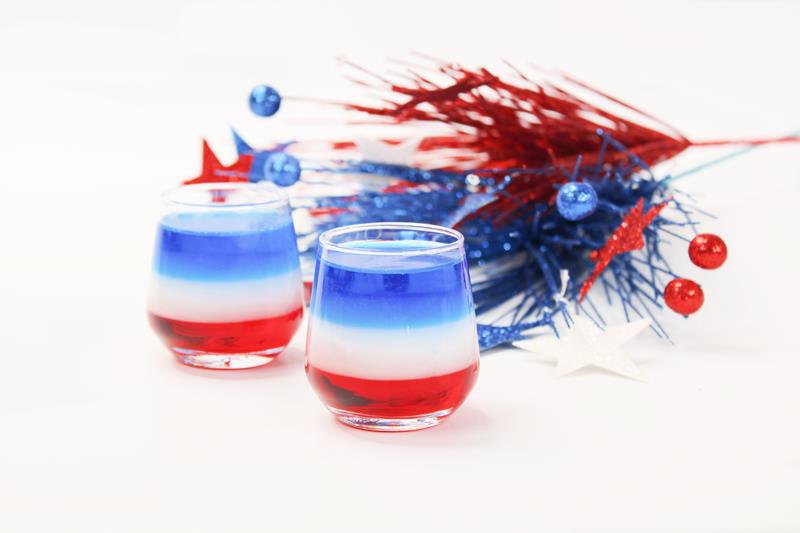 Two completed 4th of July layered shots, red at the bottom, white in the middle, and blue on the top. 