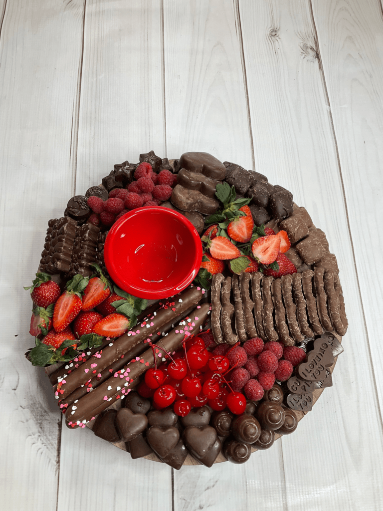 Valentine's Chocolate Charcuterie board  with everything on it but empty red bowl. 