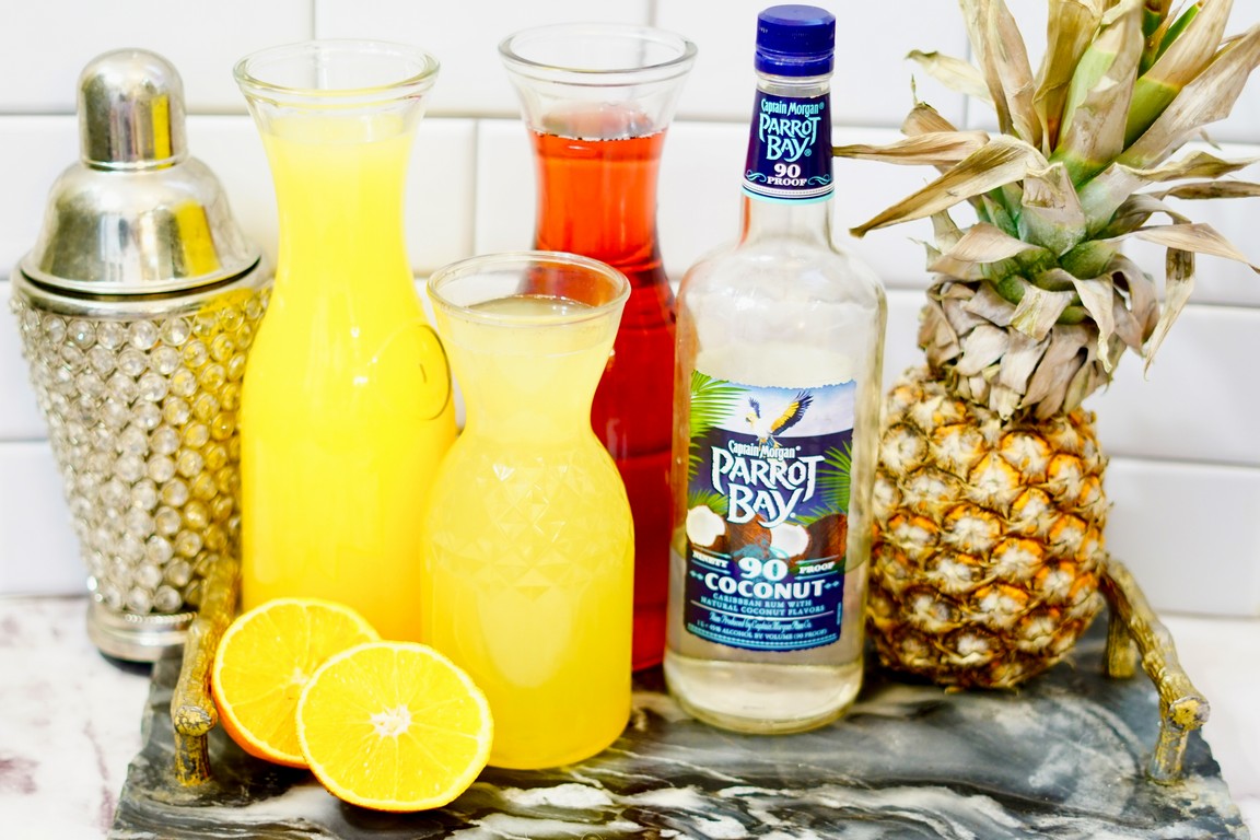 Ingredients needed: Shaker cup, orange juice, pineapple juice, cranberry juice, coconut run, fresh pineapple, orange slices. 
