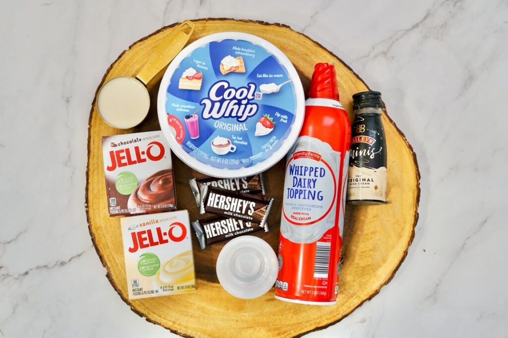 Ingredients required - chocolate, vanilla pudding boxes, cool whip container, whipped dairy topping bottle, mini heresy chocolate bars, and mini baileys bottle. 