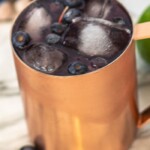 Blueberry Mule Cocktail: A Unique Twist on a Classic | Moscow Mule recipes you need to try | Blueberry cocktail recipe | Copper mug drink recipes | Summer drink recipes for everyone #Blueberry #MoscowMule #BlueberryMuleCocktail #Cocktail #CocktailRecipe #Vodka #VodkaRecipes