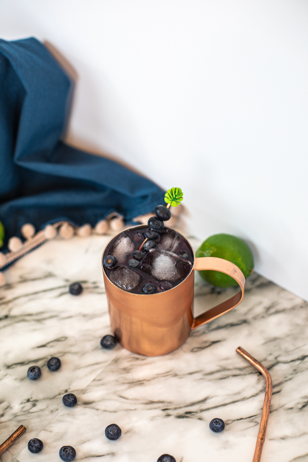 Above view of a Blueberry Mule Cocktail with lots of ice and fresh blueberries as garnish. 