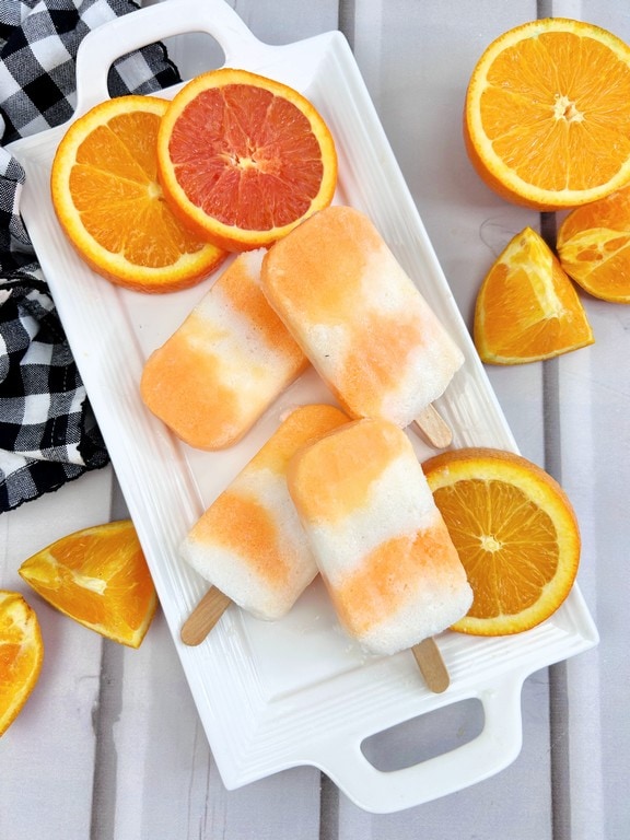 Cool Down This Summer with Boozy Orange Creamsicle Popsicles - competed popsicles. 