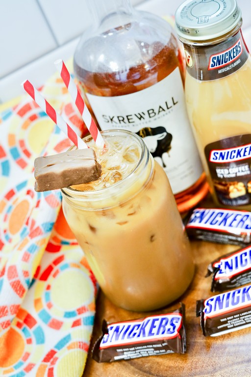 Boozy Snickers Iced Coffee - creamy light brown cocktail with tons of ice. 