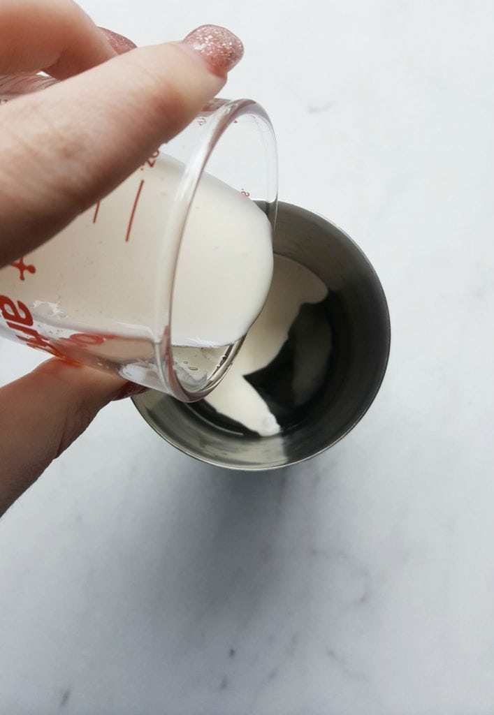 Adding heavy cream to shaker cup