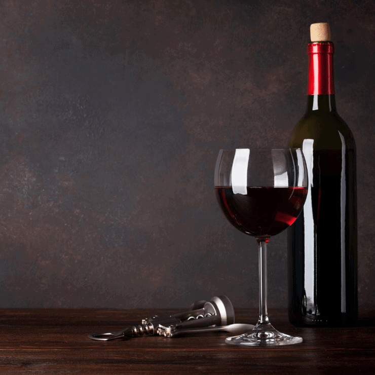 Wine bottle and glass of red wine on a table
