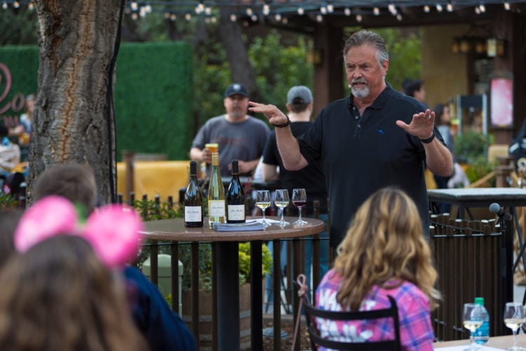 Disney Food & Wine Festival - guy talking and explaining a flight of wine standing next to a table