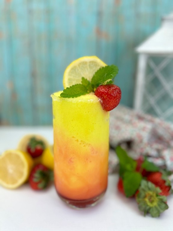 Frozen Strawberry Lemonade Cocktail - cocktail with fresh strawberries, lemon slice, and fresh mint as garnish. 