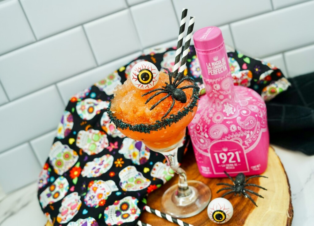 Halloween Strawberry Margarita -wooden slab with completed cocktail on it. 