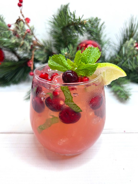 Holiday Mojito garnished with cranberries, mint, lemon and more. 