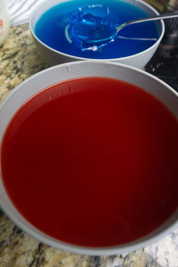 Two bowls of blue and red Jello for making alcoholic 4th of July shooters
