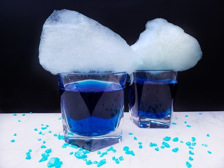 Two Genie Juice Cocktails with cotton candy on top. 