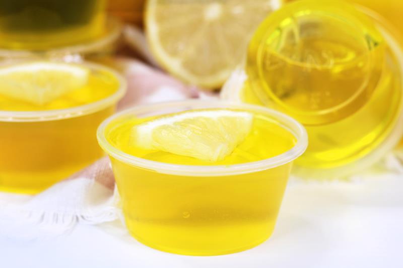 close up of lovely lemon drop jello shot with lemon wedge on top 