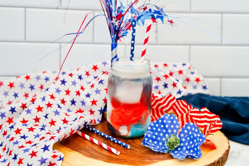Delicious Patriotic Float For Kids - completed drink with white cloth with red and blue stars beside it. 