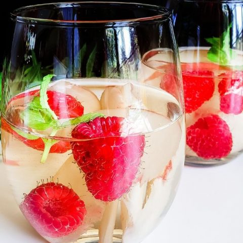 Mix up a big pitcher of this refreshing Raspberry Peach Sangria to enjoy on the patio in the summer weather. Raspberry Peach Sangria: Choose Your Own Wine| Raspberry Peach Sangria| Peach and Raspberry Sangria | Sangria Cocktails| Wine Cocktails #wine #cocktails #sangria #summerdrinks
