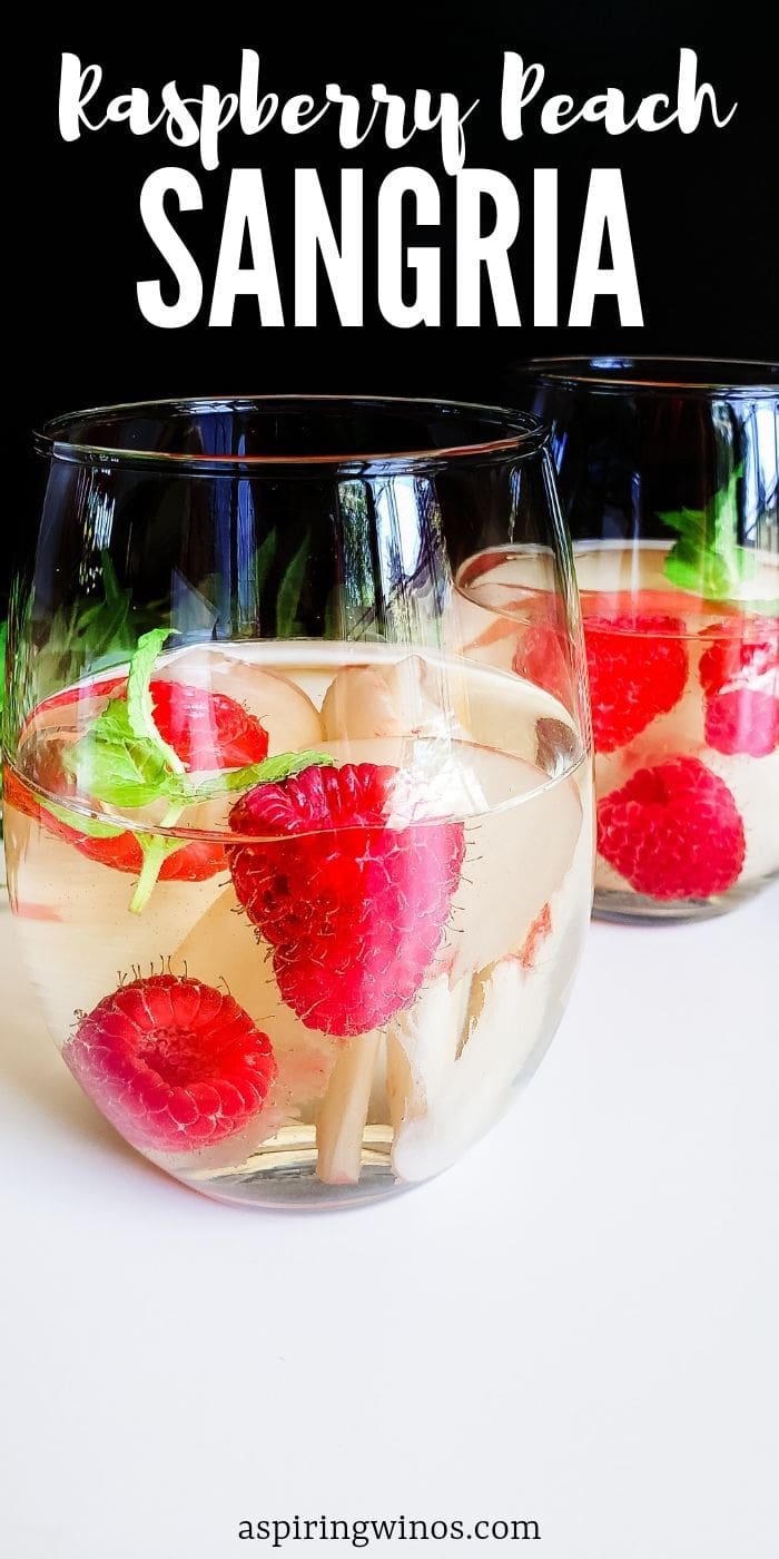 Mix up a big pitcher of this refreshing Raspberry Peach Sangria to enjoy on the patio in the summer weather. Raspberry Peach Sangria: Choose Your Own Wine| Raspberry Peach Sangria| Peach and Raspberry Sangria | Sangria Cocktails| Wine Cocktails  #wine #cocktails #sangria #summerdrinks 