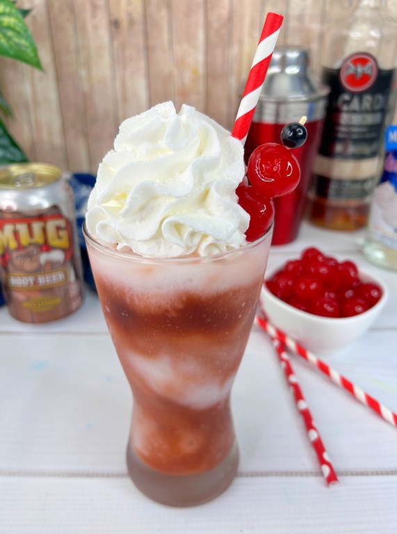 Close up of whipped cream and cherries garnish on cocktail. 