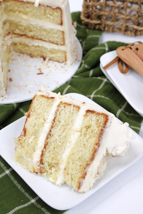 Slice of white cake with lots of rum flavored frosting