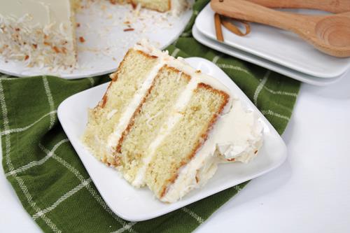 Slice of white cake with frosting made with rum