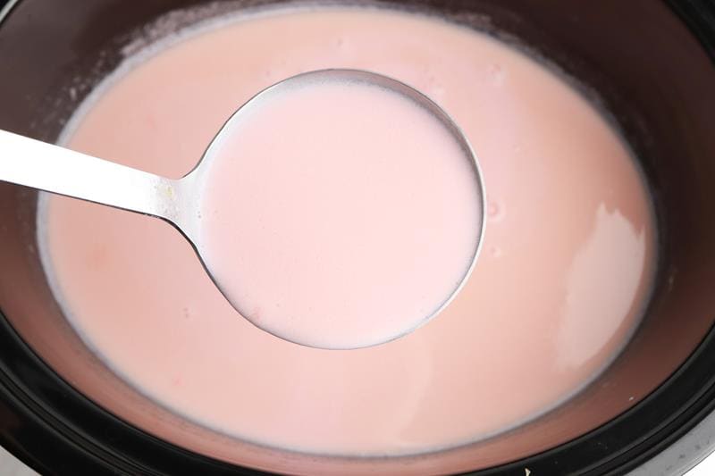 close up of pink hot chocolate in slow cooker 