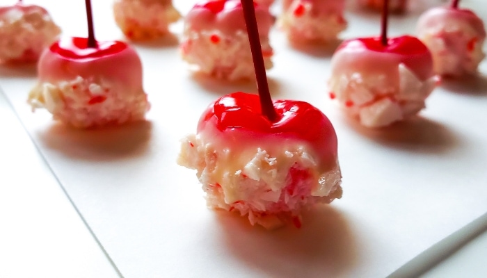 Completed Schnapps Soaked Cherry Bombs, showing cherries covered in white chocolate and crushed peppermint candies. 