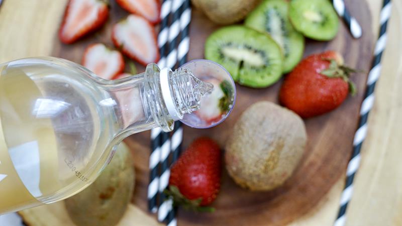 pouring strawberry vodka into shooter glass 