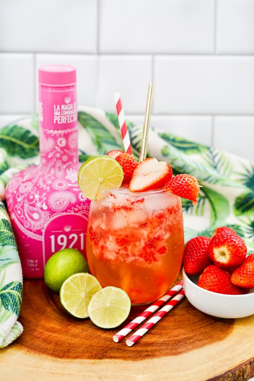 Refreshing Strawberry Tequila Soda with tons of sliced strawberries and limes as garnish. 