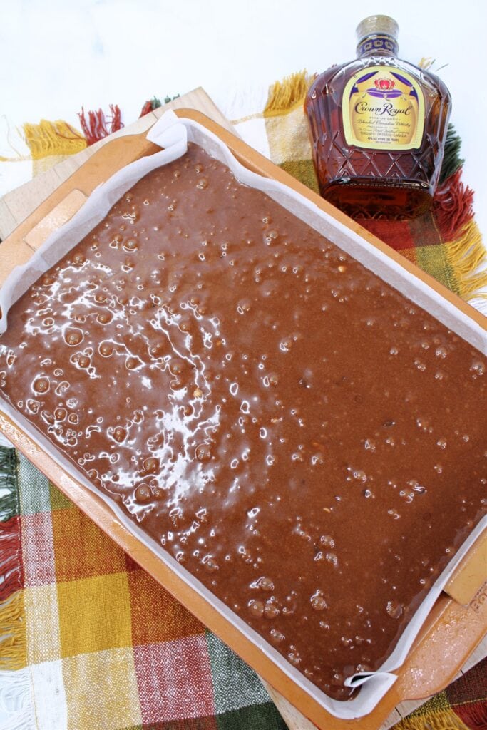 Brownie batter added to cake pan. 