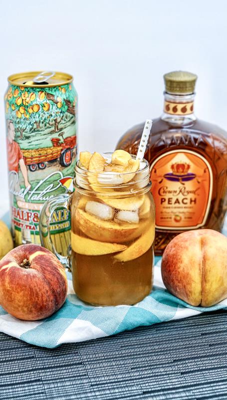 close up of crown peach drink with ingredients around it 