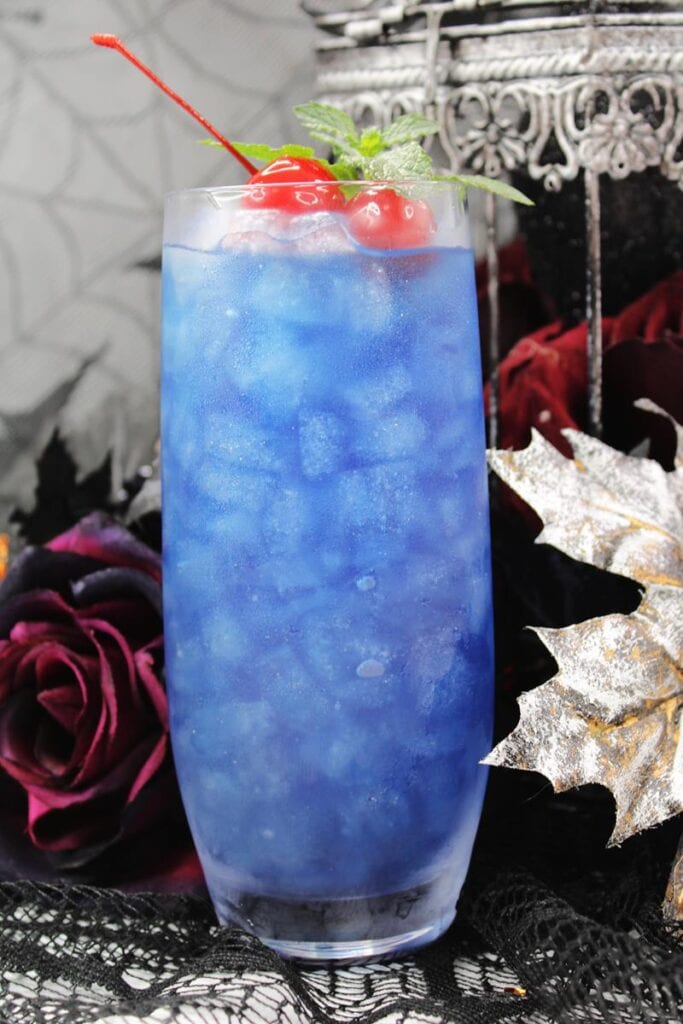 blue curacao and rum Hocus Pocus cocktail recipe with cherry garnish