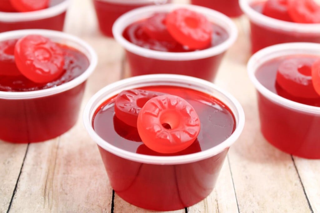 Showing various completed Lifesaver Jello Shots, all with two life savers gummies on top. 