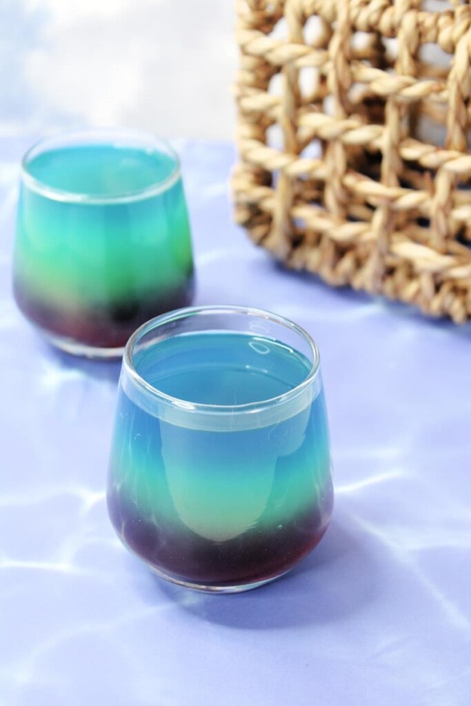 two glasses with little mermaid shot cocktail 