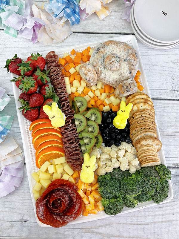 Perfect board for Easter or spring parties. Lots of fruit, vegetables, crackers, cheese, and even some yellow peeps. 