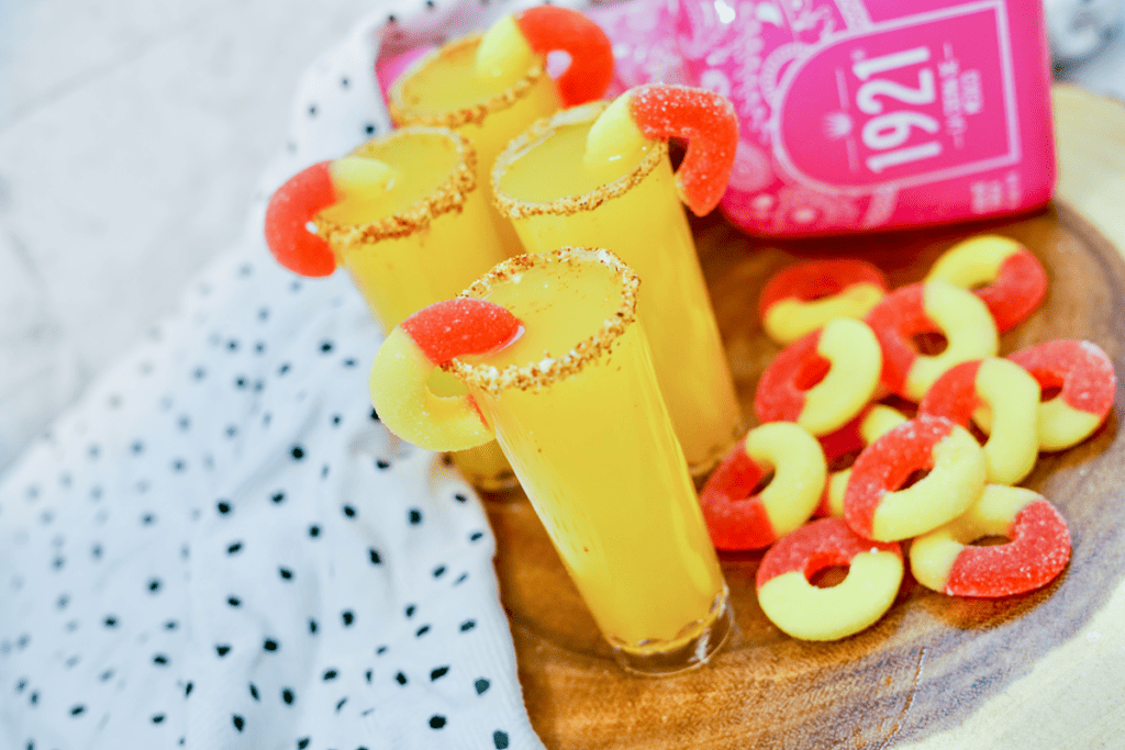 Peach Margarita Shooters - Four completed shooters with Peach rings as garnish. 