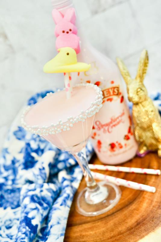 Peeps martini recipe with completed drink and baileys bottle in the background with a gold chocolate bunny. 