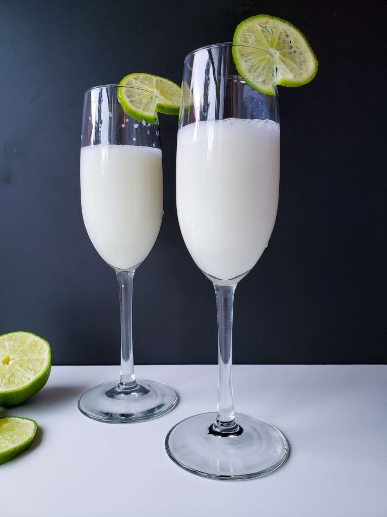 Two Margaritas served with fresh lime rounds