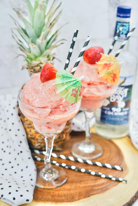 Frozen Strawberry Colada Recipe - close up of frozen drinks on a wooden slab. 