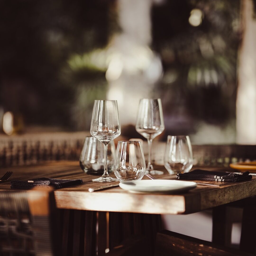 unWine'd & Tap editorial photo of empty wine glasses on a resturaunt table