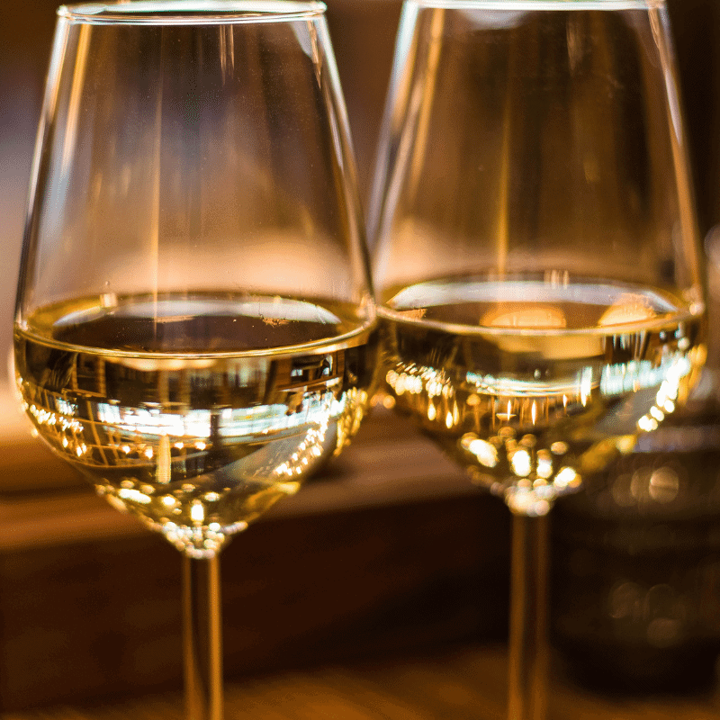 Two glasses of white wine in a tasting room 